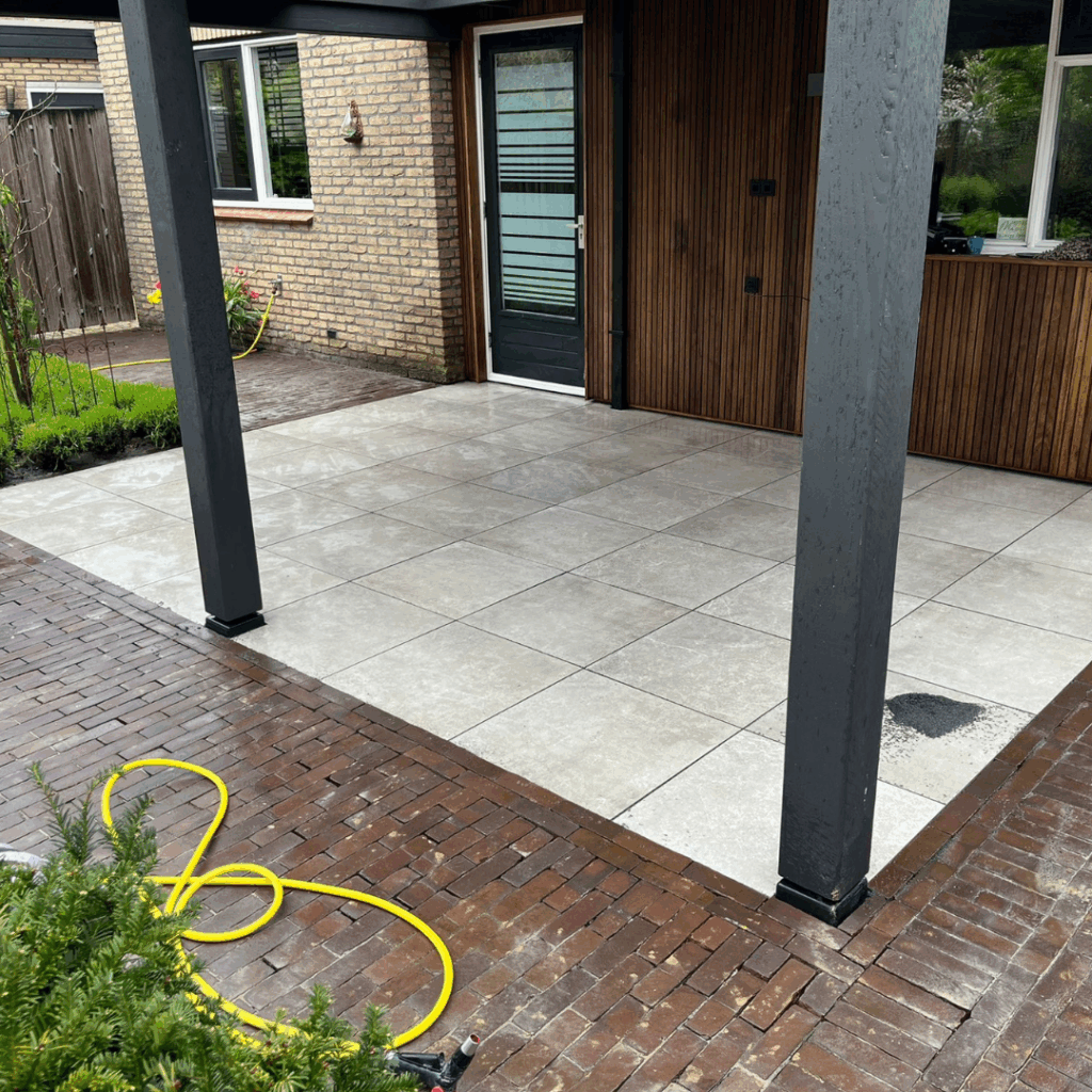 Bestrating: Aanbrengen keramische tegels, onder overkapping, in Stadkanaal